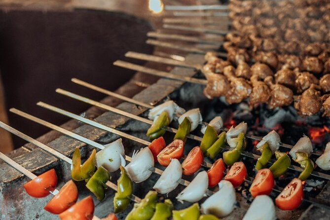 Deluxe Sunset Desert Safari: SandSurfing, Camel Ride & BBQ dinner - Dinner with table service and live BBQ: what the meal experience actually means