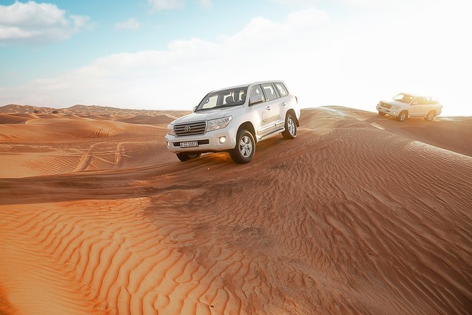 Desert Safari Dubai with Dune Bashing, Sandboarding, Camel Ride, 5 Shows, Dinner - Sandboarding and Camel Riding: Two Ways to Feel the Desert