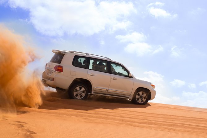 Dubai Desert Journey: Red Dunes Safari with BBQ in Bedouin Camp - Pickup, 4WD vehicles, and getting the seat you’ll thank yourself for
