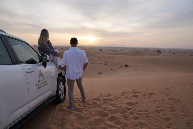 Dubai Evening Desert Safari: Sandboarding, BBQ, Camel Ride & more - Dubai Desert Conservation Reserve at golden hour
