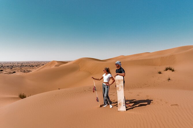 Dubai Evening Desert Safari: Sandboarding, BBQ, Camel Ride & more - Camel ride, sandboarding, henna, and falcon show at the camp