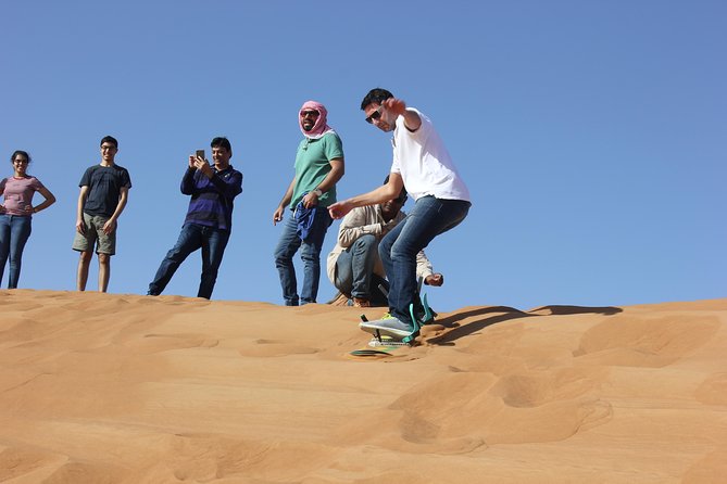 Dubai: Jeep Desert Safari, Camel Ride, and Quad Bike Tour - Al Aweer Camp: BBQ dinner and traditional entertainment