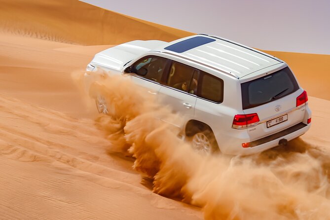 Dubai Morning Evening Desert Safari,Sand boarding and Camel ride - Sandboarding: where the dunes turn into a playground
