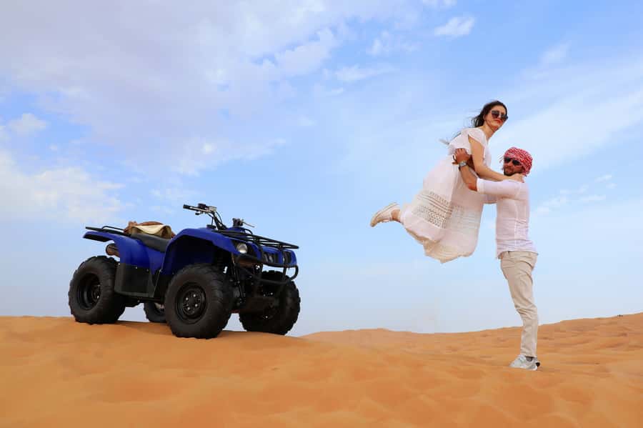 Dubai: Red Dunes Quad Bike with Sandboarding, Camels and BBQ - From Dubai to Lahbab Desert: Pickup and Early Setup