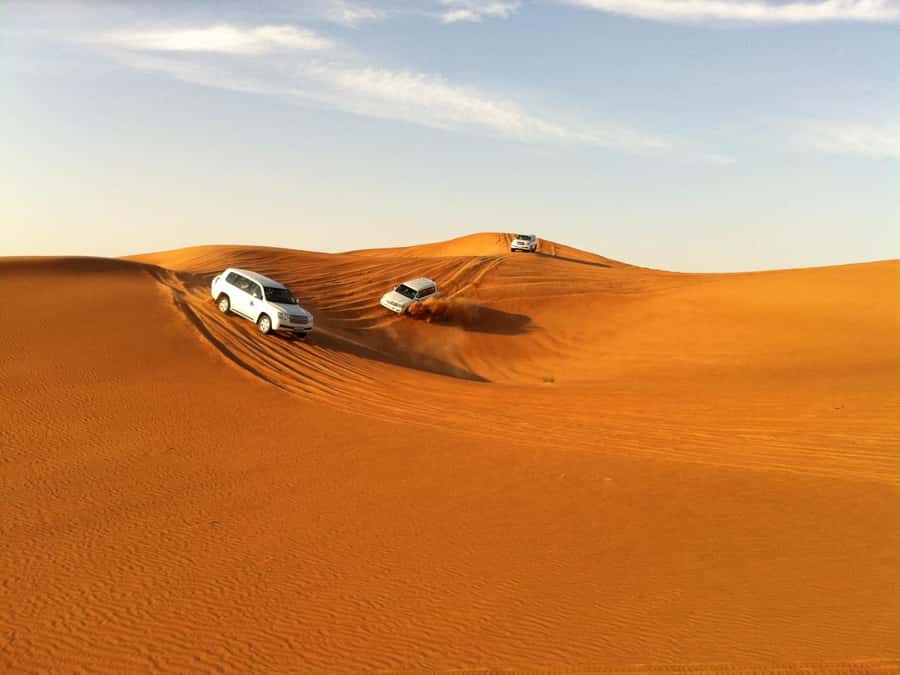 Evening Desert Dune Bashing by 4<em>4 Vehicle – Key highlights you’ll actually feel’ /></p>
<ul>
<li><strong>45-minute 4×4 dune bashing</strong> with an experienced, safety-focused driving style</li>
<li><strong>Bedouin Oasis-style camp</strong> with multiple activities, not just dinner and a show</li>
<li><strong>Sandboarding + a short camel ride</strong> so you get both thrill and a slower desert moment</li>
<li><strong>Henna painting</strong> plus local snacks and a tea and coffee counter</li>
<li><strong>BBQ buffet dinner</strong> paired with belly dance and fire dance performances</li>
<li><strong>Extras are optional</strong> (photos/souvenirs, falcon photos, quad bikes), so you can keep control of your spending</li>
</ul>
<h2 id="the-ras-al-khaimah-ride-how-the-evening-starts">The Ras Al Khaimah ride: how the evening starts</h2>
<p><img width="900" height="674" decoding="async" src=