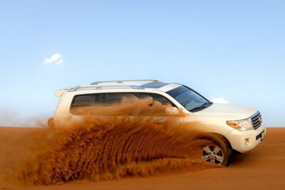 Evening Desert Safari in Dubai, Sandboard & BBQ Dinner - Getting to Lahbab High Red Dunes in a 4x4 SUV