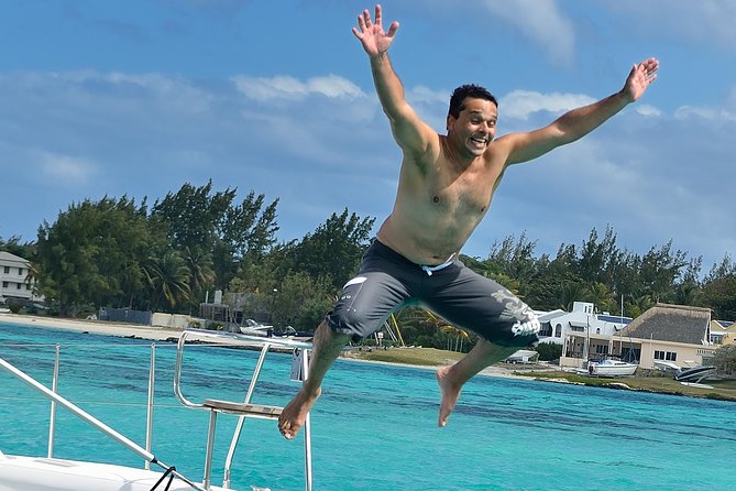 Full-Day Catamaran Cruise to Île aux Cerfs with BBQ Lunch - Onboard vibe: sega music, friendly hosts, and dolphin chances