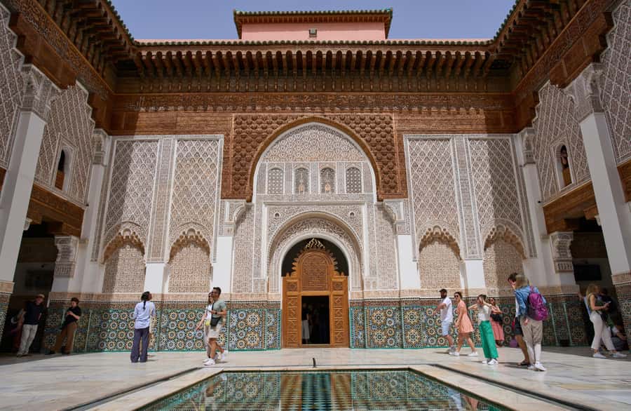 Marrakech: Madrasa Ben Youssef, Secret Garden & Medina Tour - Koutoubia Mosque stop: iconic landmark, quick but meaningful