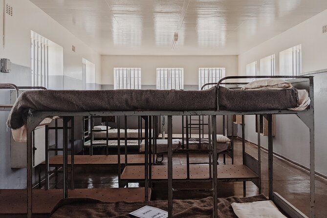 Robben Island Tour including Pick Up & Drop Off from Cape Town - Ferry, Walk to the Buses, and the Prison-Built Wall You’ll Pass