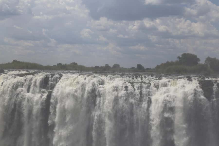 Zimbabwe & Zambia: Guided Tour of the Falls from Both Sides - Zimbabwe side: rainforest trails, deeper context, and a market stop for real mementos